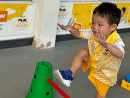 A child happily steps over an obstacle during playtime.