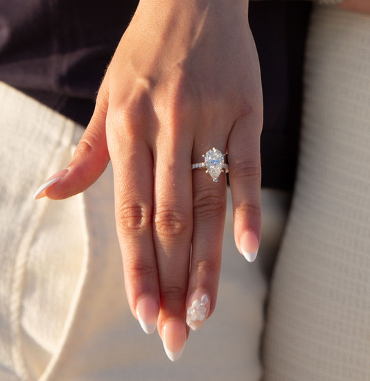 Woman's hand showcasing a diamond ring