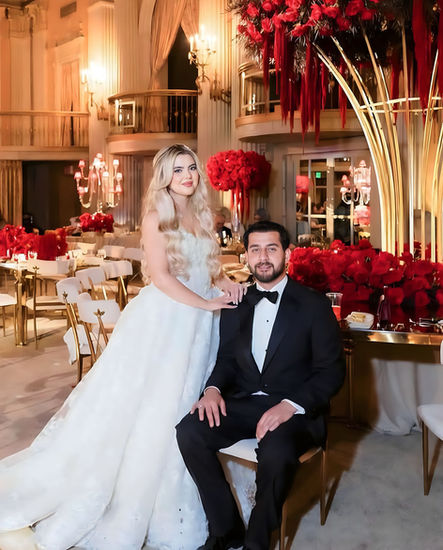 Bride and groom in elegant wedding attire pose for a photo