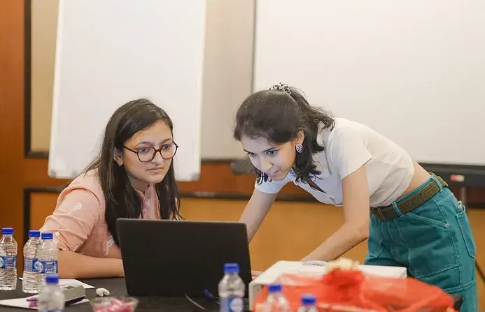 Two people working together on their laptop