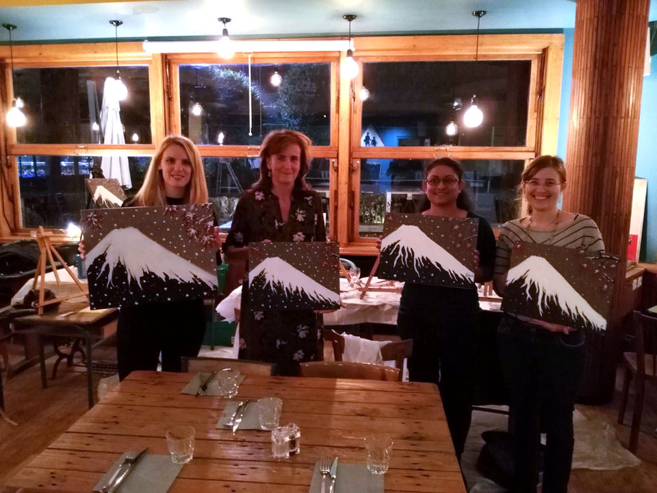 Anna Karen with participants holding their paintings at the end of an Ar’pero workshop in Montrouge.