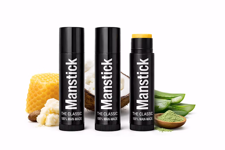 Three Manstick tubes with their raw organic ingredients