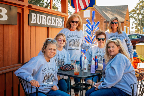 Women in matching sweatshirts at B Burgers