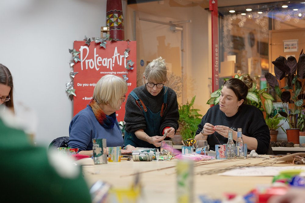 Debbie Todd running an art workshop in her studio, teaching art students how to undertake a creative task.