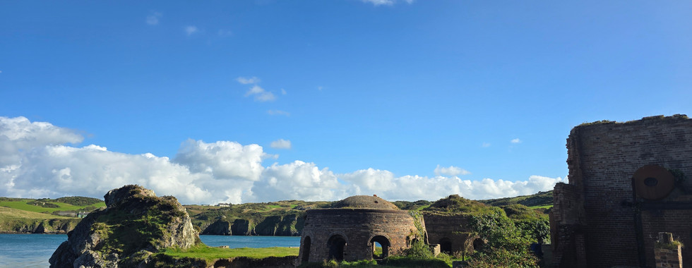 strange shaped building at Porth Wen Beach and the old brickworks site at Traeth