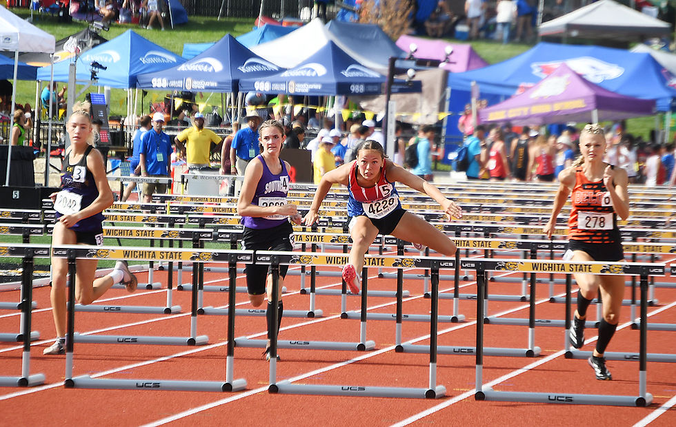 Wellsville senior Ellie Strain, second from right, clears the final hurdle en route to winning the Class 3A 100-meter hurdles She also won the 300-meter hurdles.