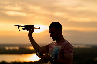 silhouette-man-piloting-drone-sunset-wit