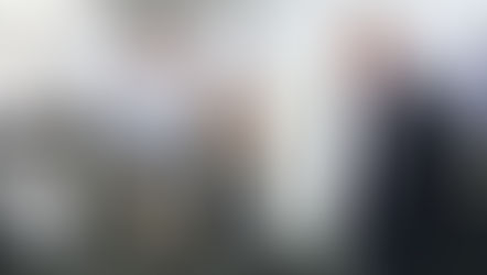 Two men in an electronics lab looking at a piece of bomb neutralising equipment.