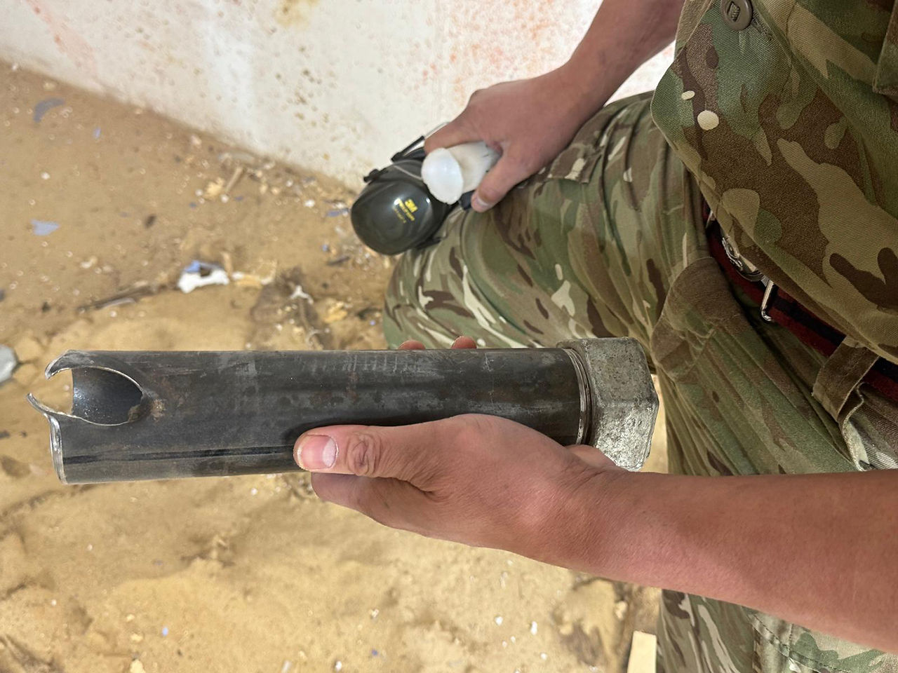 Inspecting the dummy device post deployment of the disruptor to assess it effectiveness.