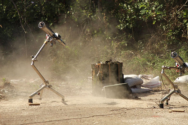 A UXO prior to having its fuze removed with an EOD tool.