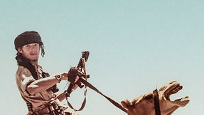 An old photograph of a soldier on a camel