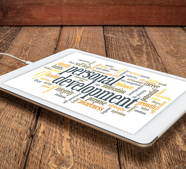 cloud of words or tags related to personal development on a digital tablet against rustic