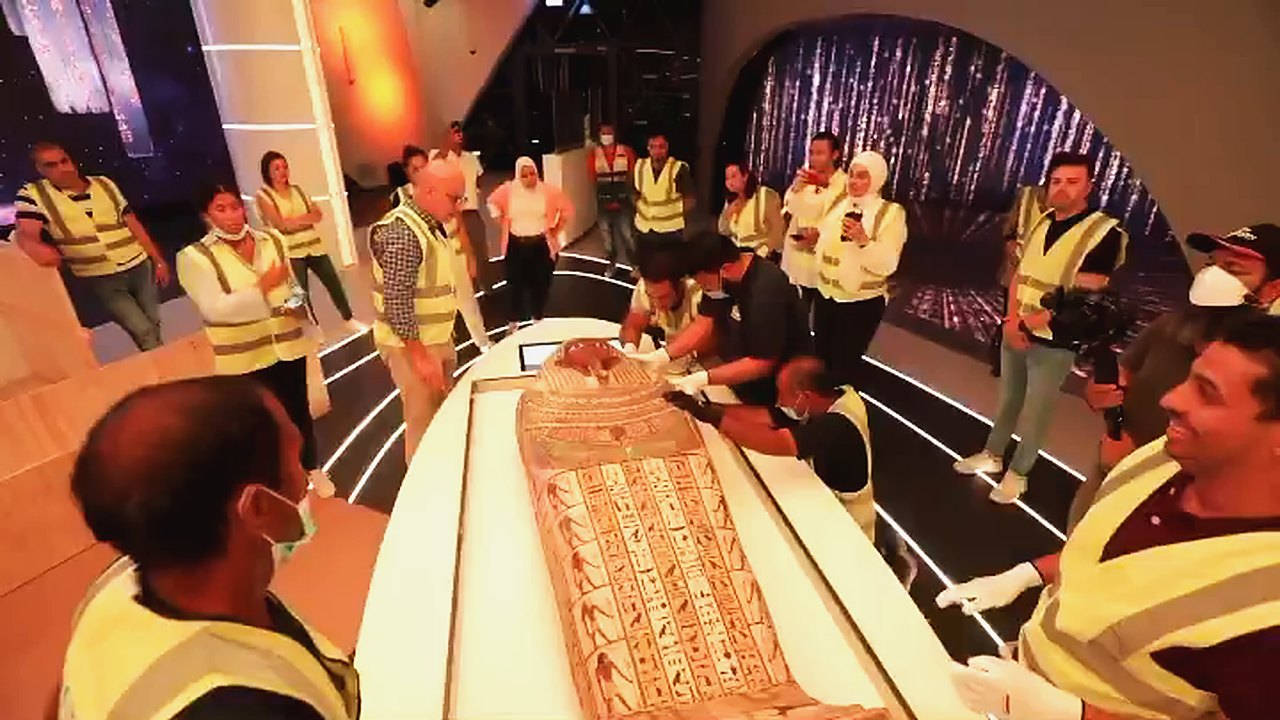 Handlers placing the ancient coffin in the Egypt Pavilion