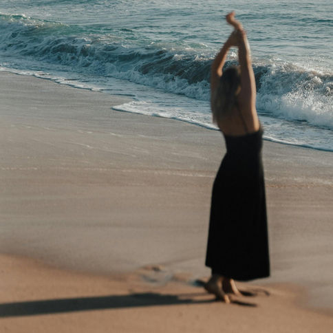 A woman dancing on the beach