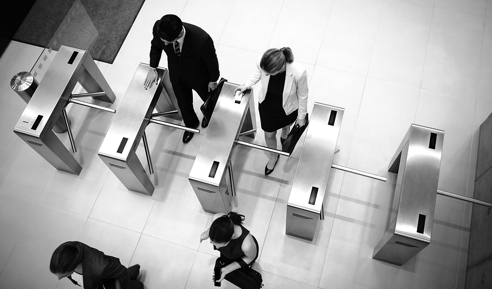 Top view of business executives passing through turnstile gate.jpg