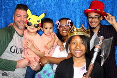 Group posing in photo booth with fun props