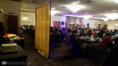 Attendees seated at tables in a large event space