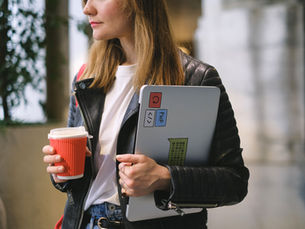 Freelance translator working at desk with laptop and reference materials