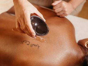 Massage oil warmer on treatment cart in spa room