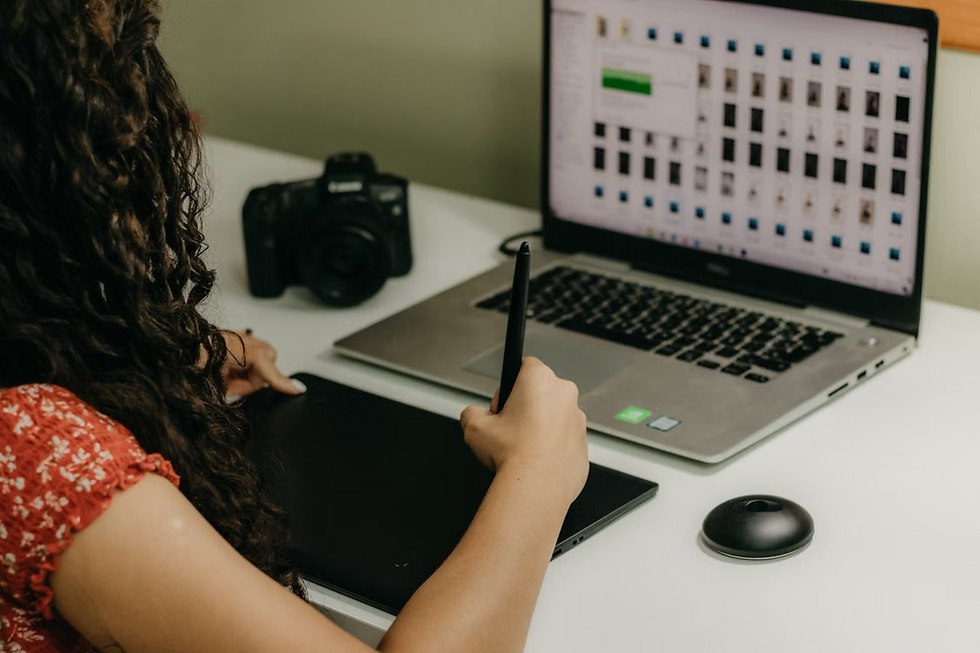 Professional graphic designer workstation with a color-accurate monitor, digital drawing tablet, stylus, color swatches, and design software open.