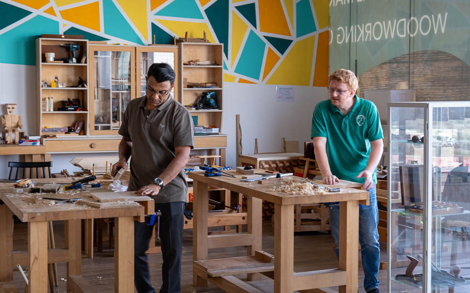Woodworking class participants in Dubai learning hand tool techniques through The Makers Society’s gift card experience.