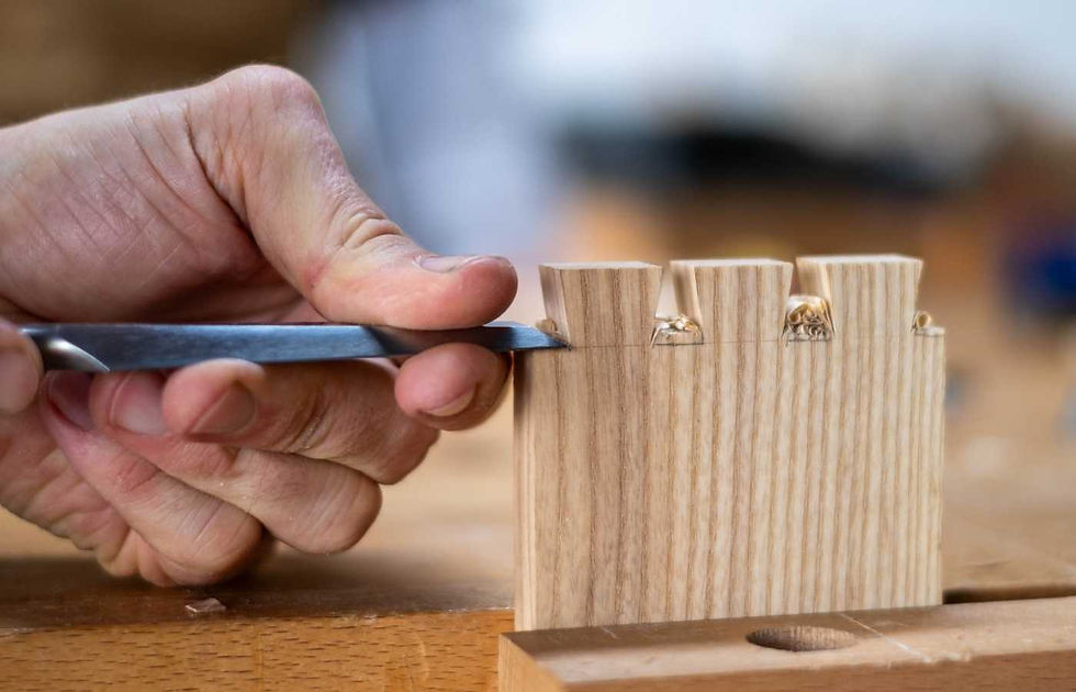 Close-up of a student cutting dovetail joints with a chisel
