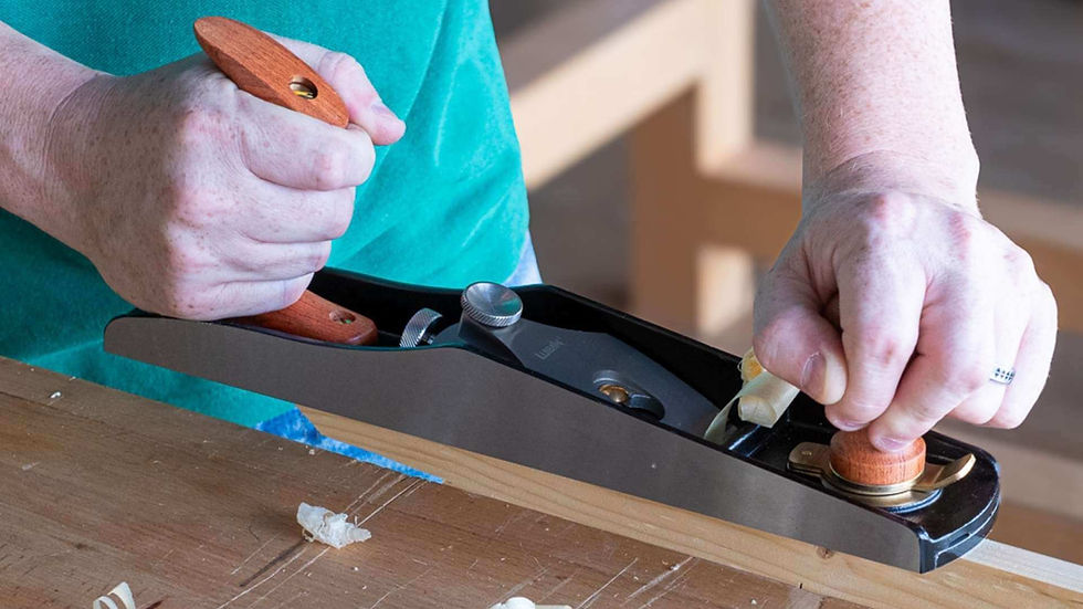 Woodworker shaving a board with a premium Luban hand tool during a class in the UAE