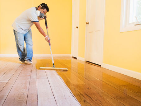 Hardwood floor repair and refinish restoring worn natural wood flooring.