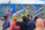 Travelers listening to a local guide during a graffiti tour in Bogotá
