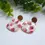 Thumbnail: Close-up of handmade strawberry earrings with polymer clay and wood studs – quirky fruit-themed earrings.