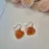 Thumbnail: Elegant heart-shaped brass earrings with artisan polymer clay details, perfect for unique jewellery lovers.