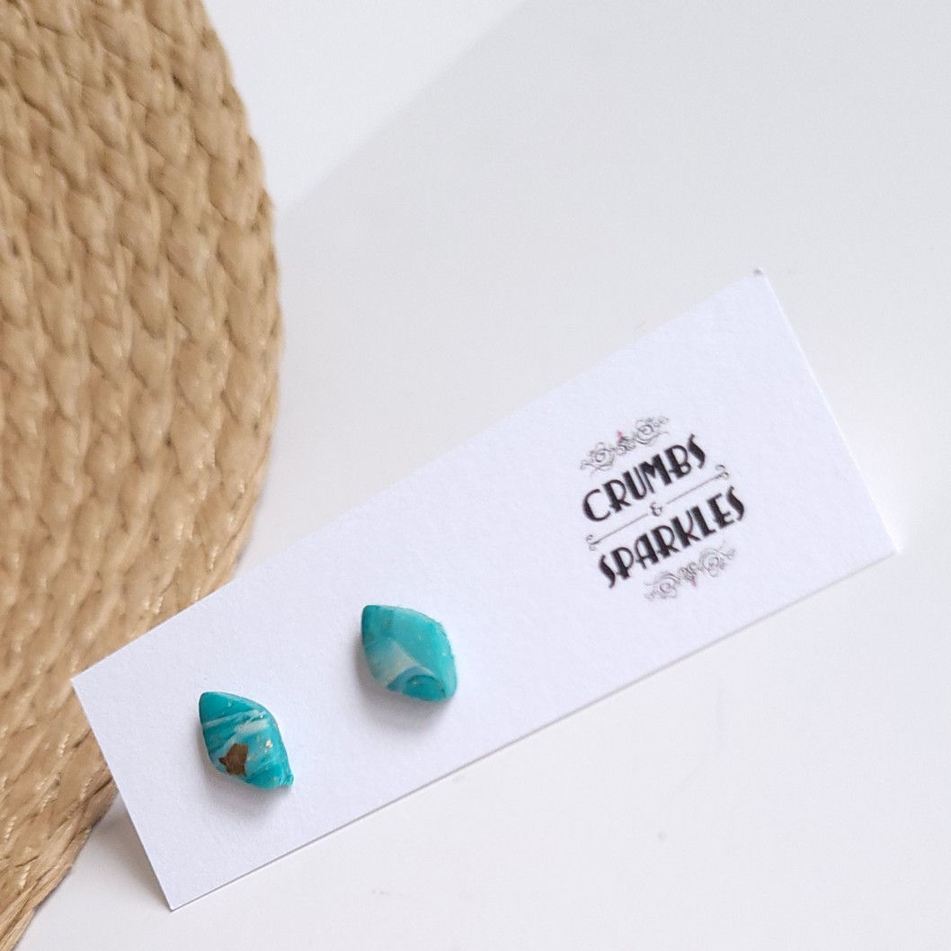 Green Diamond Polymer Clay Stud Earrings on White Background with Crumbs and Sparkles Branding