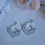 Thumbnail: Handmade grey and white statement earrings with leopard print detail.