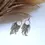 Thumbnail: Gold hoop earrings with green seed bead tassels