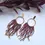 Thumbnail: Handcrafted red beaded earrings with gold hoops