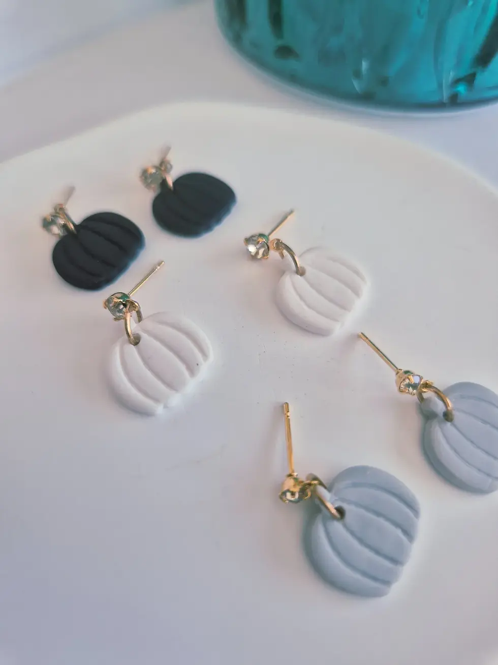 Handmade pumpkin polymer clay earrings in black, white and grey