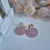 Thumbnail: Dusty rose round clay earrings with gold bow studs and embossed starburst design
