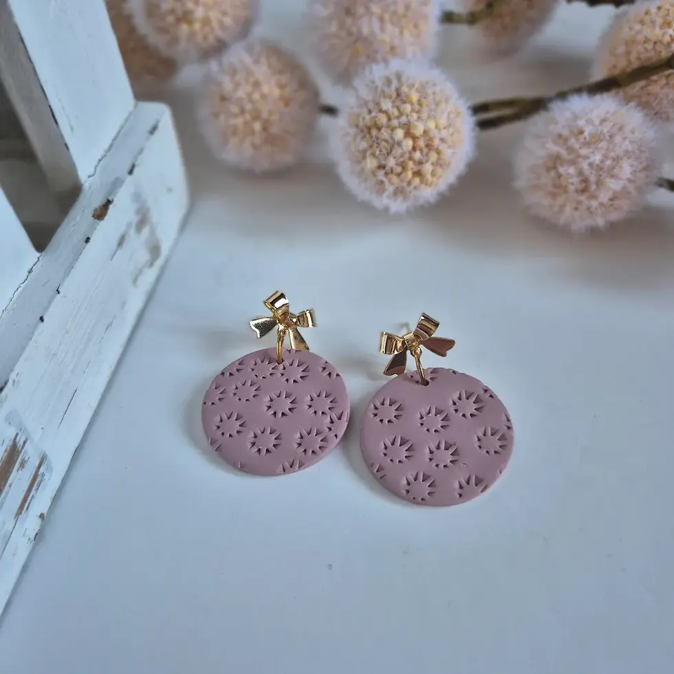 Dusty rose round clay earrings with gold bow studs and embossed starburst design