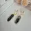 Thumbnail: Elegant black handmade statement earrings with marbled clay and resin and gold detailing