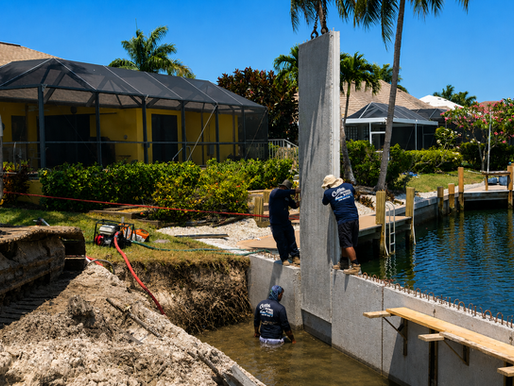 Collier Seawall And Dock LLC workers installing a brand new seawall panel.
