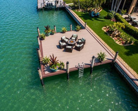 Aerial view of a new dock featuring a seating area. Built By Collier Seawall and Dock LLC.