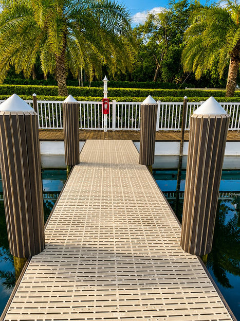 New dock construction with composite decking and pilings. Built By Collier Seawall and Dock LLC.