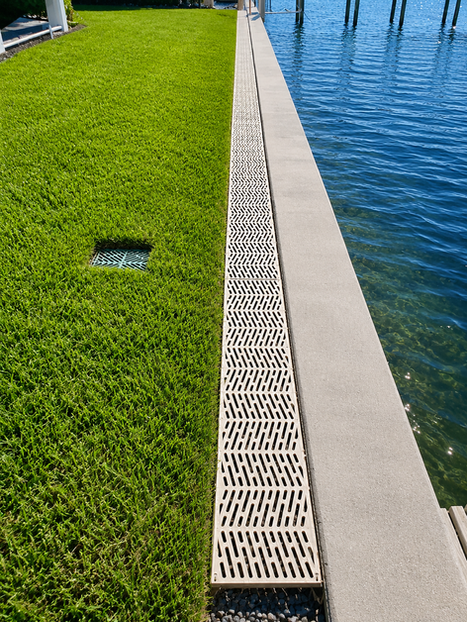New vinyl seawall construction with drain guard, built by Collier Seawall and Dock LLC.
