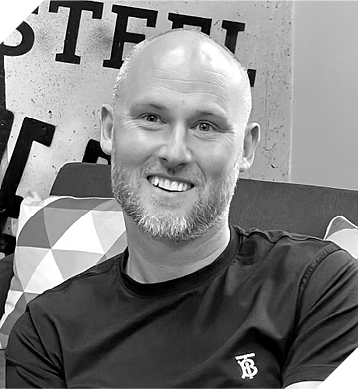 A Professional Business Man in black and white, smiling at the camera