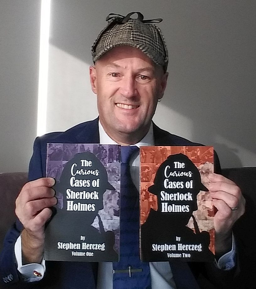 Steve Herczeg holding his two Sherlock Holmes collections