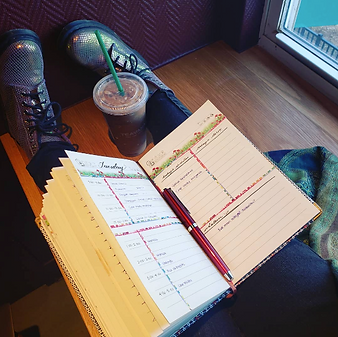 An open planner and pen