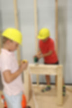 boys playing pretend in construction site