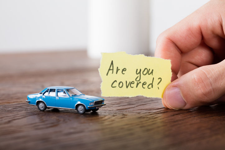 A toy car with a sign, Are You Covered?