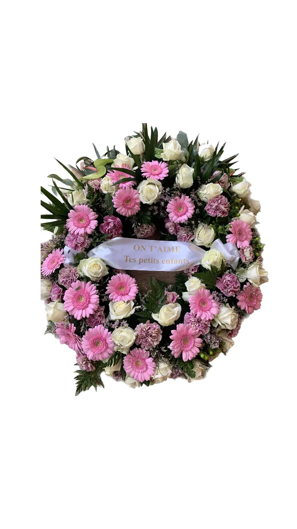 Couronne de fleurs de deuil composée de roses blanches et de gerberas roses, avec un ruban "On t'aime Tes petits enfants".
