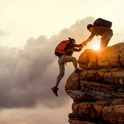Rock climber helping another rock climber